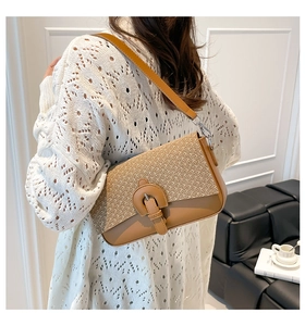 Detail of vintage patchwork shoulder bag featuring straw weave and brown leather textures