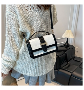 Detail of contrast stitch shoulder bag with diamond quilting and gold metal lock