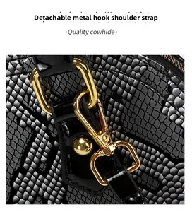 Detail of snake skin texture cowhide leather bag with detachable gold metal hardware buckle
