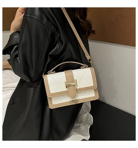 Detail view of contrast color crossbody bag with geometric texture and gold hardware