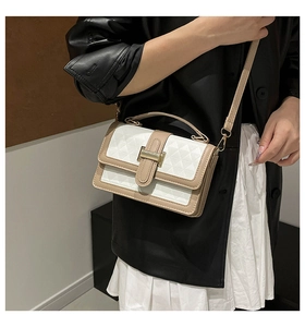 Detail of color-block flap handbag with geometric embossing and gold hardware