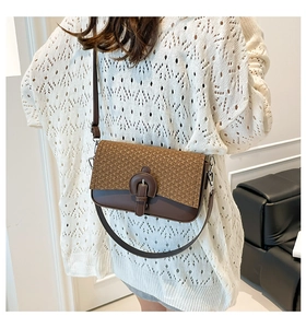 Detail of vintage patchwork crossbody bag with brown woven texture on a female model