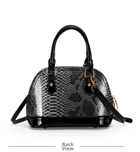 Detail view of the shell bag back with snake pattern texture and black patent leather