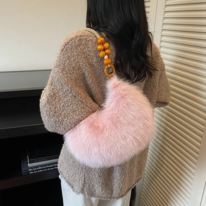 Pink plush faux fur underarm bag with orange wooden beads on a bohemian shoulder strap