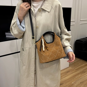 Retro brown suede bucket bag with white diamond quilting and wooden bead tassels