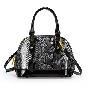 Elegant snake print shell bag in black patent leather with golden hardware for women
