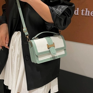 Chic quilted crossbody bag in green and white with gold lock on a model shoulder