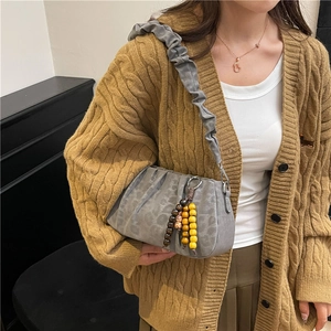 Retro grey pleated underarm bag with colorful wood bead charms on model