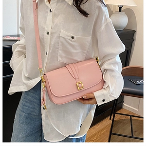 Pink faux leather crossbody bag detailing dual straps and gold metallic buckle