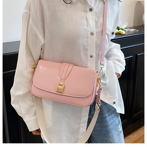 Detailed shot of pink PU leather crossbody bag with wide strap and gold buckle