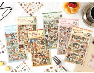 Flat lay of retro lifestyle stickers for scrapbooking including six themed design sheets