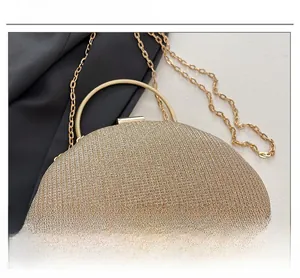 Close-up of gold sequin evening clutch featuring metal handle and shimmering fabric
