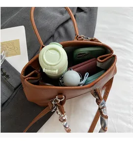 Spacious interior of brown textured bucket bag with scarf and daily essentials