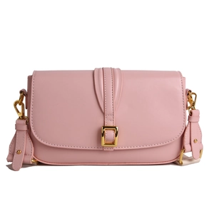 Pink faux leather crossbody flap bag with wide strap and gold hardware on white background