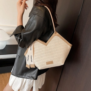 Fashionable straw tote bag with brown leather trim and shoulder straps for women
