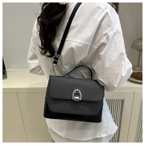 Detailed back view of a two-tone crossbody bag with grey woven texture and silver buckle