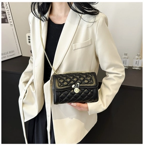 Quilted leather small bag with gold rabbit clasp and chain strap on a model
