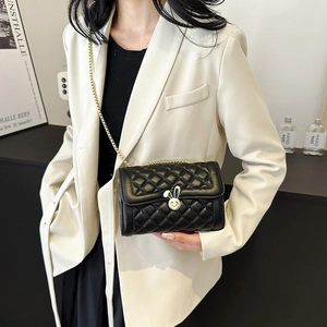 Chic black quilted crossbody bag with golden bunny ears lock and metal chain strap