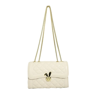 Quilted cream chain shoulder bag with unique golden rabbit ear lock on white background