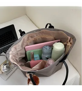 Vue intérieure du grand sac cabas montrant des compartiments spacieux et multiples poches