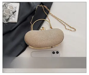 Champagne gold evening clutch with glitter texture, rhinestone crown clasp, and chain strap