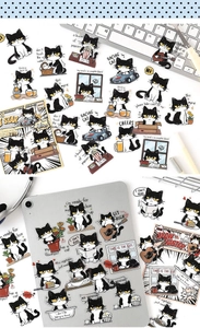 Détail d'autocollants de chats noirs et blancs mignons sur un ordinateur et une tablette