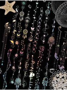 Macro view of holographic laser stickers with celestial moon and marine dreamscape designs