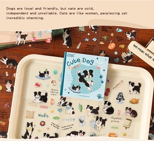 Detailed view of Border Collie plush stickers and packaging on a cream tray