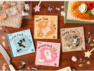 Detail view of cute pet sticker packs including cat and dog themes on a wooden desk