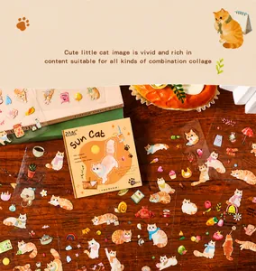 Detailed view of 20pcs cute orange PET stickers featuring sun cats on a wooden desk
