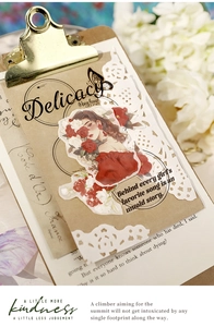 Detail of vintage scrapbooking stickers featuring a girl, flowers and quotes on kraft paper