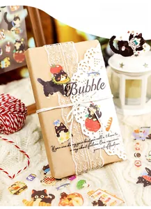 Black cat decorative stickers applied on a craft paper gift wrap with lace and cotton twine