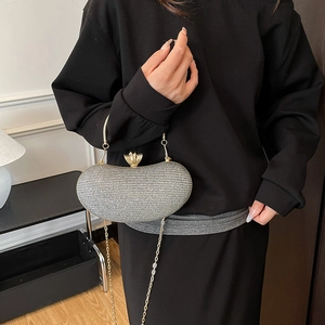 Elegant silver glitter clutch bag with metallic clasp and chain strap for evening events