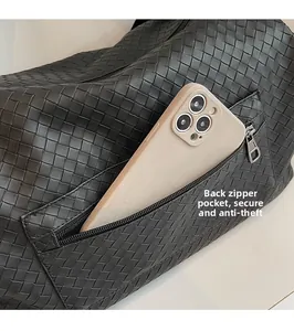 Detail of a woven travel bag showing a secure back anti-theft zipper pocket with smartphone