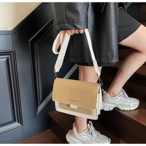 Detail of retro color-block crossbody bag with ginger yellow matte texture and wide strap