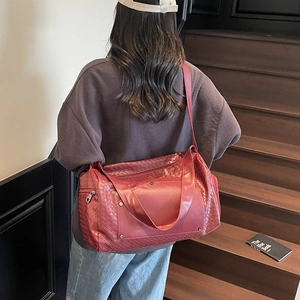 Large burgundy woven texture travel duffle bag for sports and weekend getaways