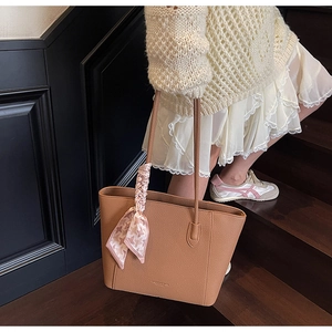 Détail du grand sac cabas en cuir grainé marron avec foulard en soie à carreaux décoratif