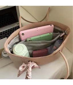 Top view of pink leather tote bag showing spacious interior with laptop and organizer