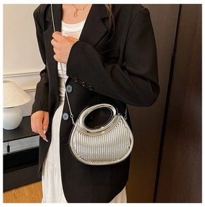 Silver crescent clutch with vertical pleats, mirror finish, and elegant chain strap