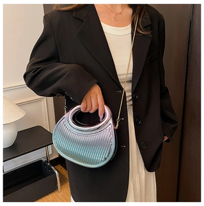 Close-up of crescent acrylic handbag in iridescent silver with fine vertical texture