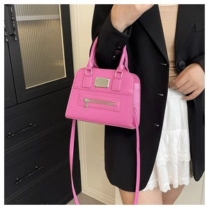 Detail view of pink PU leather square handbag featuring dual handles and metal zipper accents