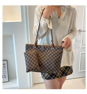 Detail of classic brown checkered tote set with matching pouch and slim leather handles