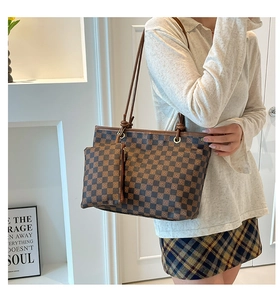 Detail of vintage checkered tote bag set with a small matching zippered pouch
