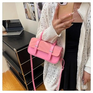 Close-up of pink box bag featuring marble texture lid and silver hardware clasp