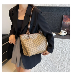 Detail view of checkerboard tote bag set with brown leather straps and knotted accents