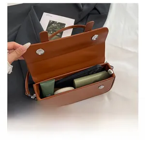 Brown leather handbag interior showing large capacity for phone, wallet and cosmetics