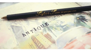 Macro shot of 1.0mm eco-friendly paper barrel ballpoint pen with gold foil lettering