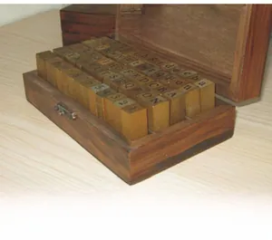 Detailed view of 70 pieces vintage wooden alphabet and number stamp set in a wooden box