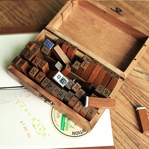 Vintage wooden alphabet and number stamp set with 70 pieces in a rustic storage box