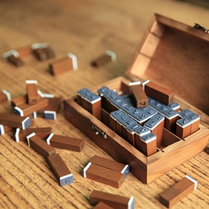Vintage 70-piece wooden alphabet and number stamp set in a rustic wooden storage box
